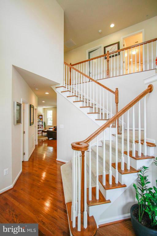 10502 Windlass Run Road Baltimore, MD 21220 - Photo 18 of 26 a view of staircase with lots of frames on wall and a chandelier