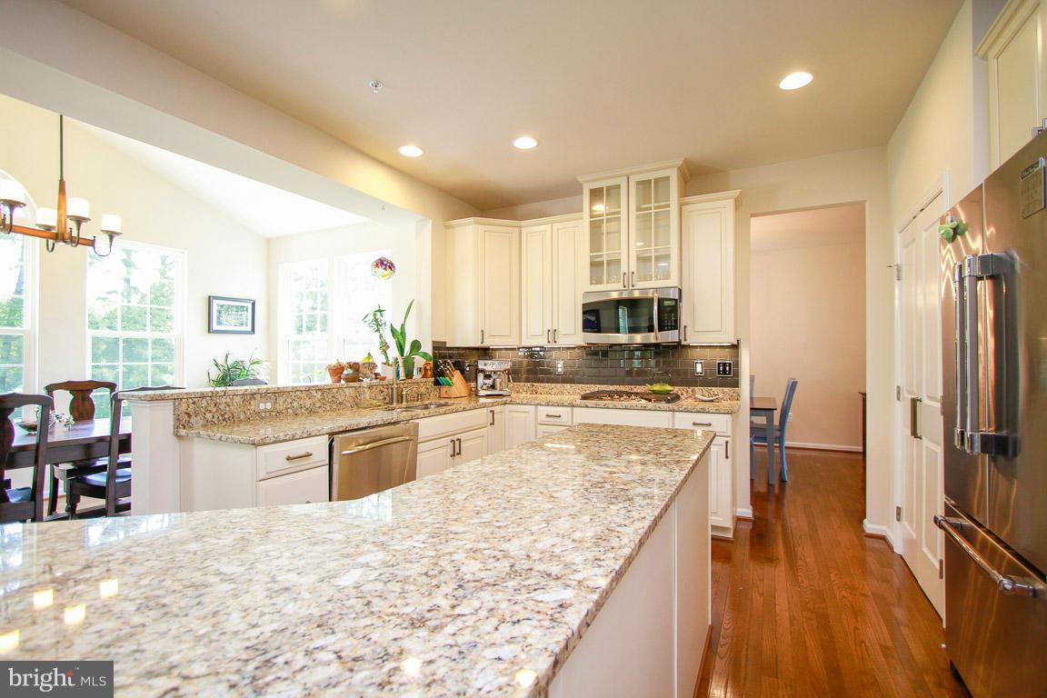 10502 Windlass Run Road Baltimore, MD 21220 - Photo 5 of 26 a large kitchen with kitchen island a counter top space a sink stainless steel appliances and cabinets