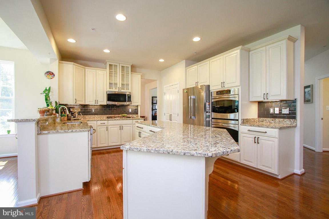 10502 Windlass Run Road Baltimore, MD 21220 - Photo 6 of 26 a kitchen with stainless steel appliances granite countertop a sink refrigerator stove and microwave