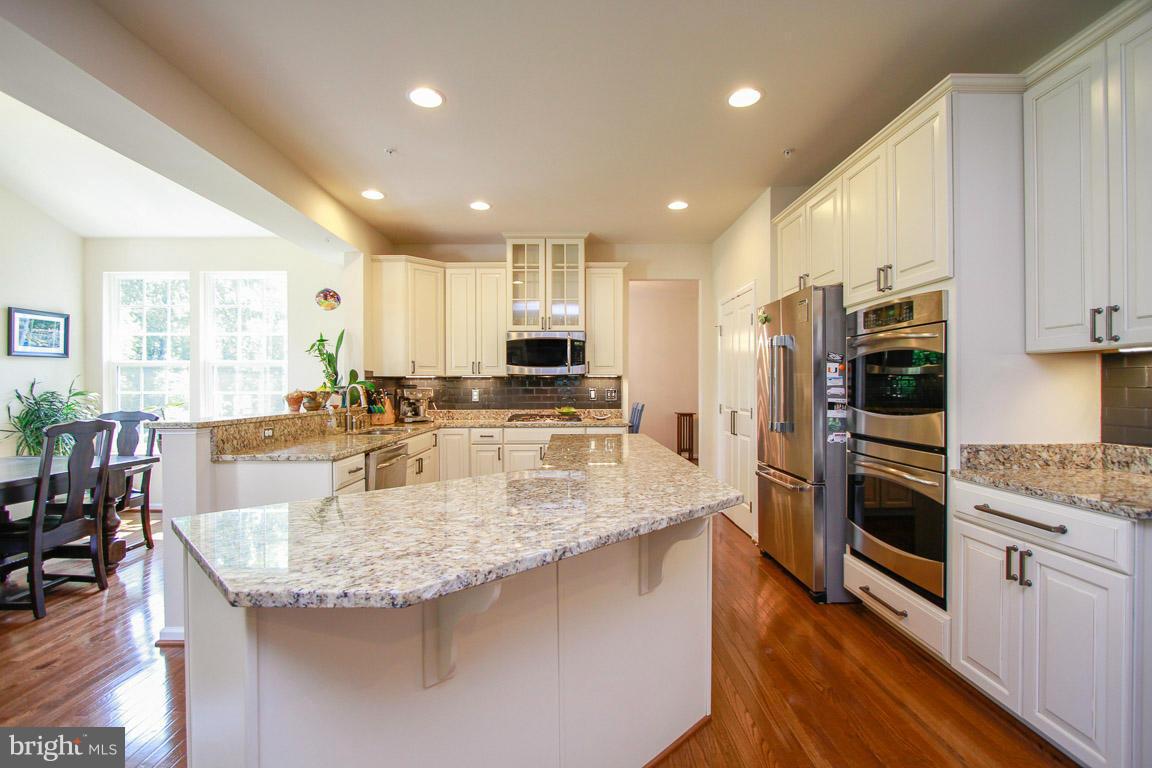 10502 Windlass Run Road Baltimore, MD 21220 - Photo 7 of 26 a kitchen with stainless steel appliances granite countertop a sink refrigerator and cabinets