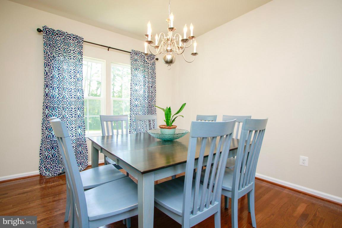 10502 Windlass Run Road Baltimore, MD 21220 - Photo 9 of 26 a view of a dining room with furniture window and wooden floor