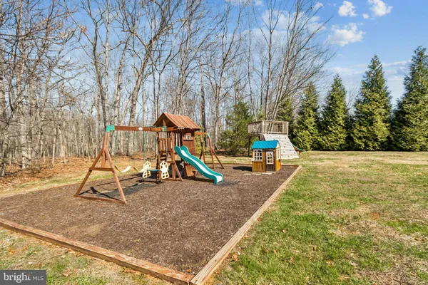 a view of outdoor space with playground and green space