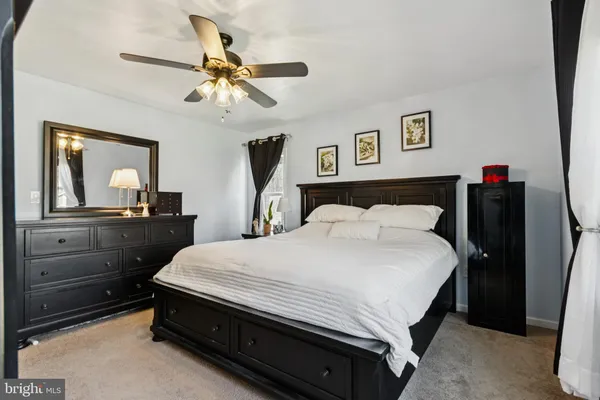 a bedroom with a bed and a dresser