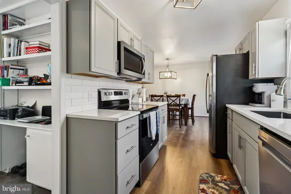 a kitchen with stainless steel appliances granite countertop a sink and cabinets