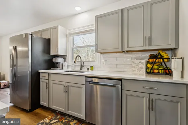 a kitchen with stainless steel appliances refrigerator and stove