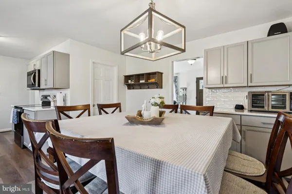 a view of a dining room with furniture wooden floor and chandelier