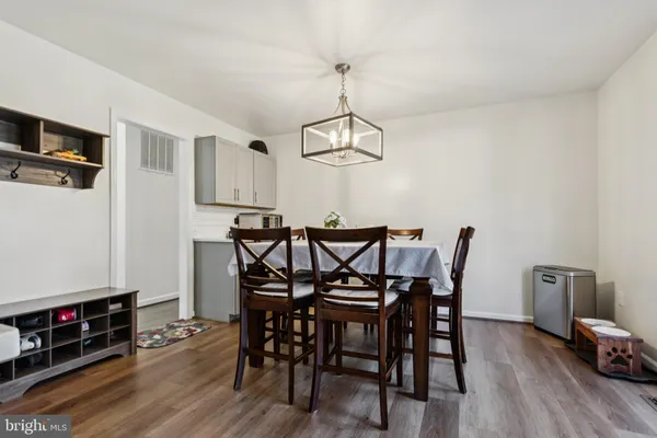 a view of a dining room with furniture and chandelier