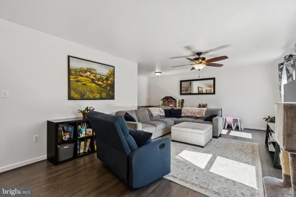 a living room with furniture and painting on the wall