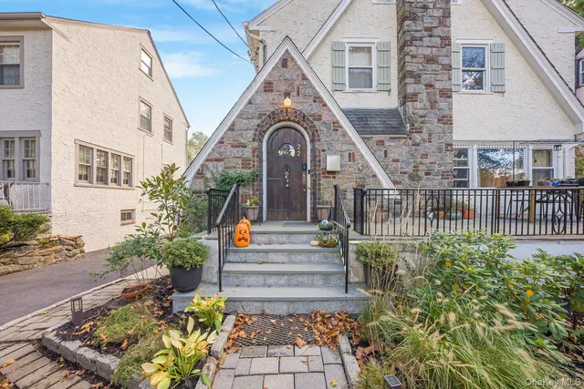 a front view of a house with a garden