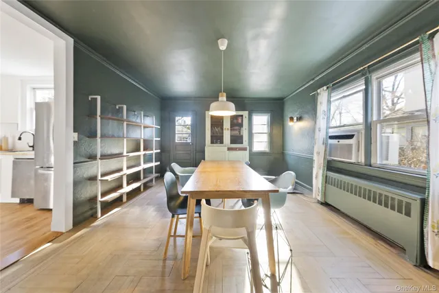 a very nice looking room with a large window and furniture