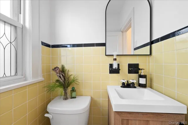 a bathroom with a sink a toilet and a mirror