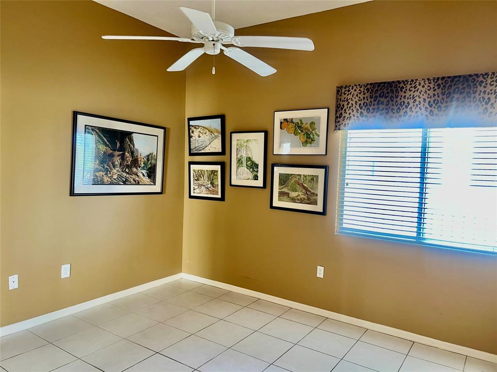 9539 Weldon Circle, Unit F406 Tamarac, FL 33321 - Photo 14 of 22 a view of an empty room with a fan
