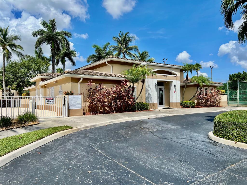 9539 Weldon Circle, Unit F406 Tamarac, FL 33321 - Photo 18 of 22 a front view of a house with garden
