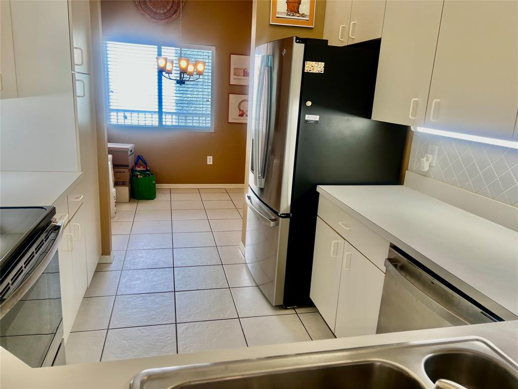9539 Weldon Circle, Unit F406 Tamarac, FL 33321 - Photo 3 of 22 a kitchen with a refrigerator and a stove
