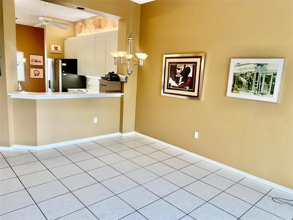 9539 Weldon Circle, Unit F406 Tamarac, FL 33321 - Photo 4 of 22 a bedroom with a bed and a painting on the wall