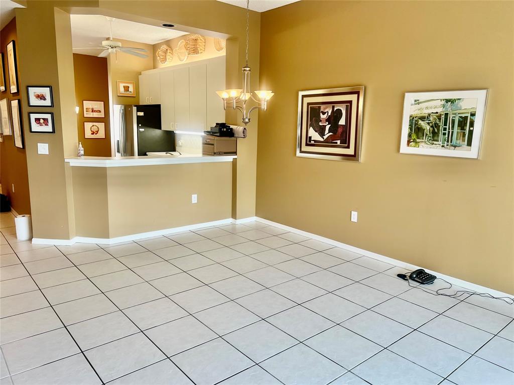 9539 Weldon Circle, Unit F406 Tamarac, FL 33321 - Photo 6 of 22 a bedroom with a bed and a cabinets