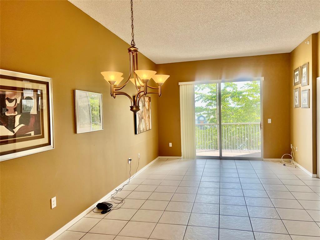 9539 Weldon Circle, Unit F406 Tamarac, FL 33321 - Photo 7 of 22 a view of a room with a large window