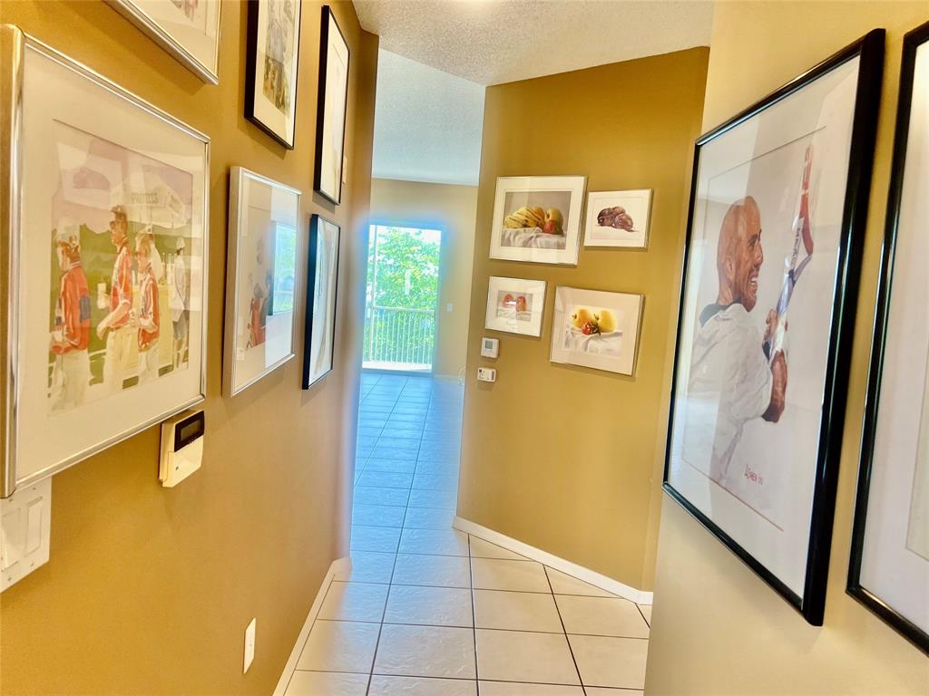 9539 Weldon Circle, Unit F406 Tamarac, FL 33321 - Photo 8 of 22 a view of a hallway with wooden floor and door