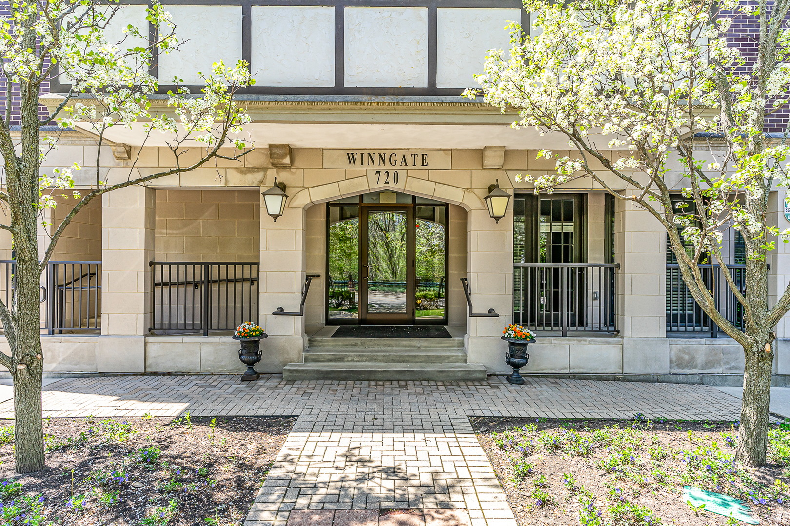 a front view of a building with a garden