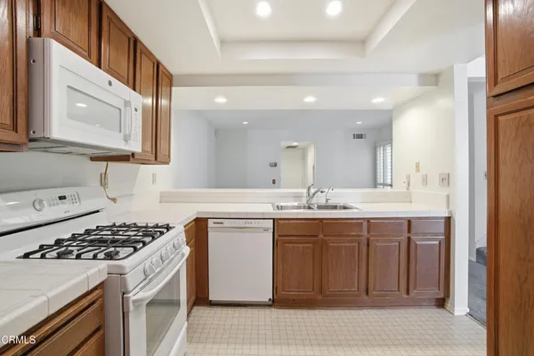 a kitchen with a sink stove and cabinets