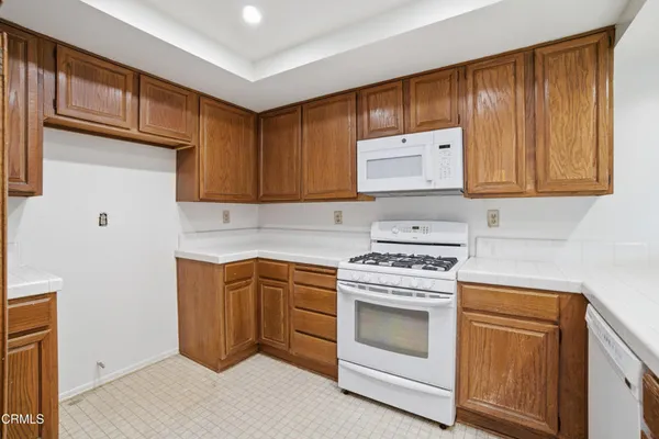 a kitchen with granite countertop cabinets stainless steel appliances and a sink
