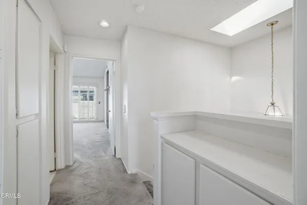 an empty room with a ceiling fan and a window