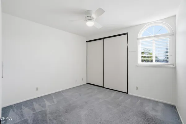 a room with window and ceiling fan
