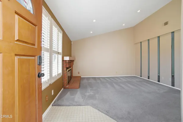 a view of an empty room and a window