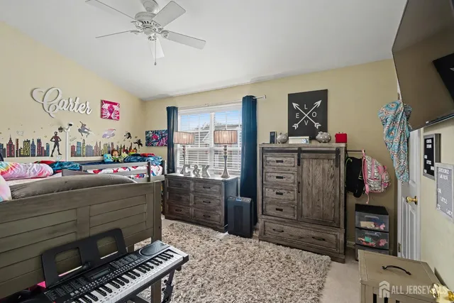 a living room with furniture a flat screen tv and a dresser