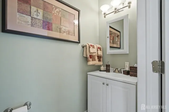 a bathroom with a granite countertop sink mirror and vanity