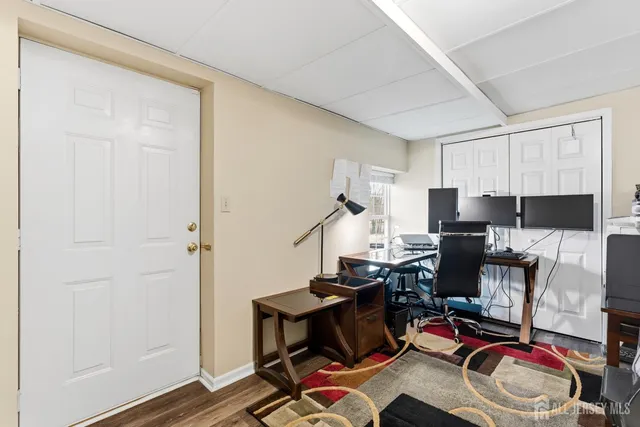a view of a workspace with furniture and a window