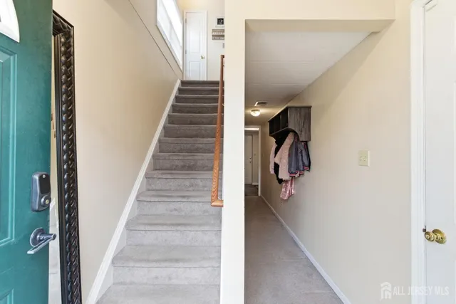 a view of entryway and hall with wooden floor