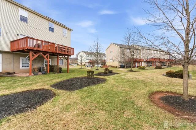 a view of a house with a yard and sitting area