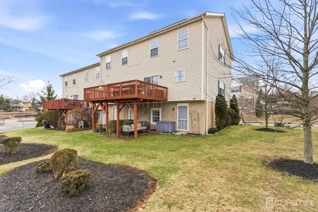 a view of a white house with a big yard and large trees