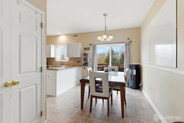a dining area with furniture and a chandelier