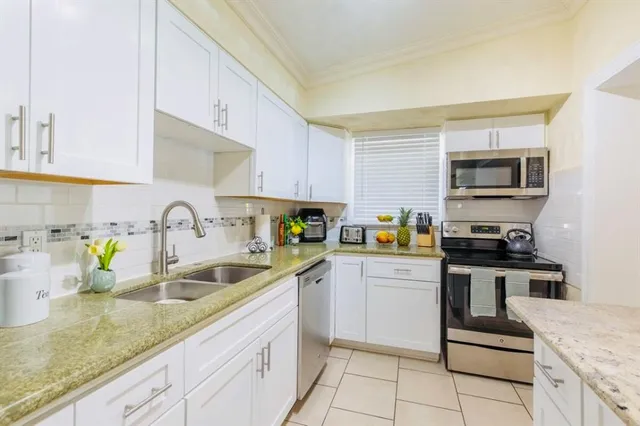 a view of a hallway with dining area and glass door