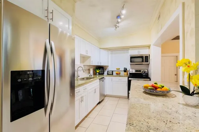 a kitchen with a stove a sink and a microwave