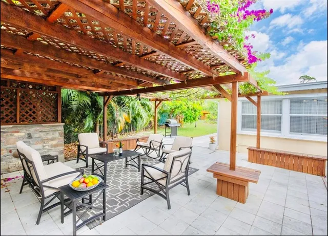 a building outdoor space with patio furniture and potted plants