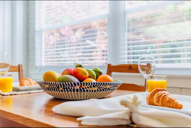 a bedroom with a bed and a lamp on dresser