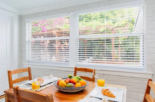 a bedroom with a large bed and a wooden floor