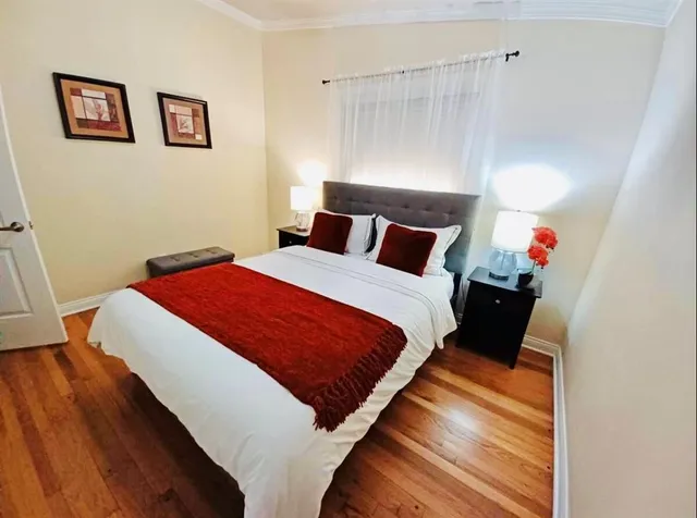 a bed sitting in a bedroom next to a window