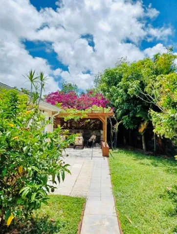 a view of a room with wooden floor and a curtain