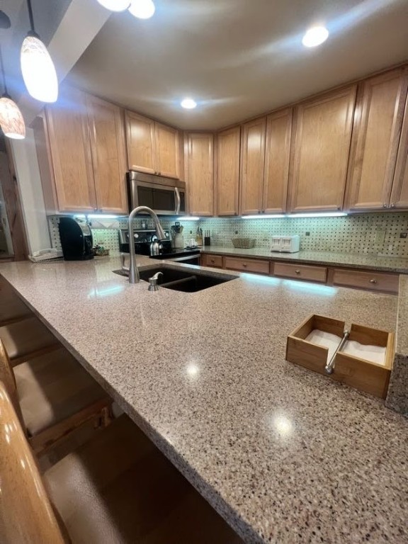 1937 Soda Ridge Road, Unit 1122 Keystone, CO 80435 - Photo 11 of 39 a kitchen with a sink a counter top space cabinets and stainless steel appliances