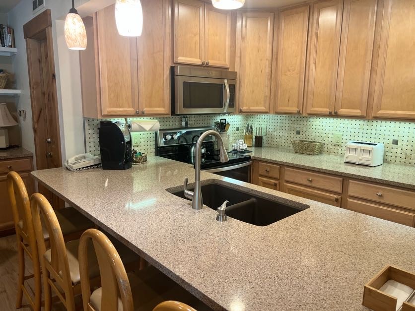 1937 Soda Ridge Road, Unit 1122 Keystone, CO 80435 - Photo 19 of 39 a kitchen with a sink a counter top space cabinets and stainless steel appliances