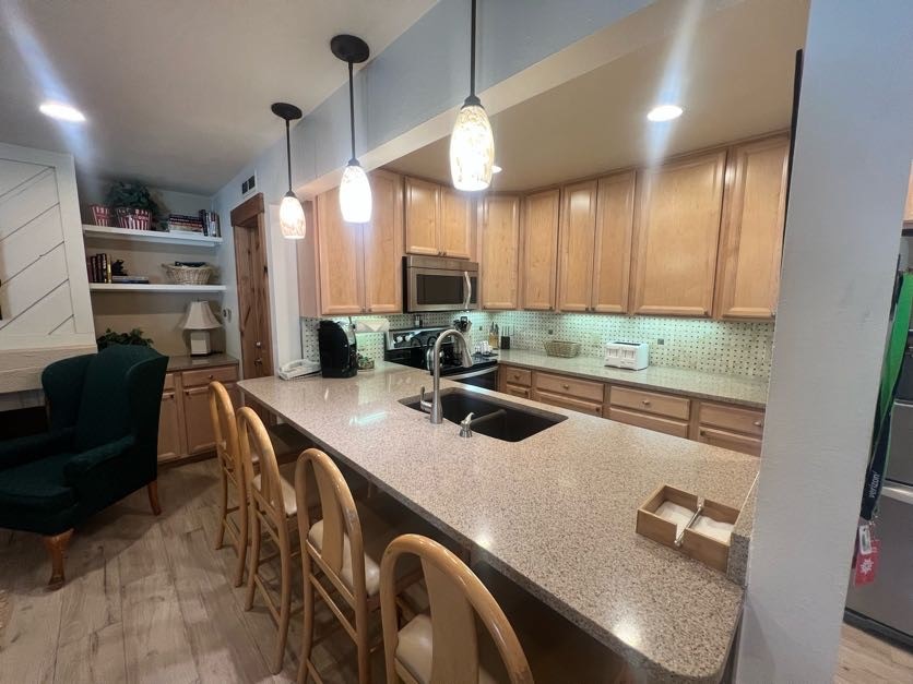 1937 Soda Ridge Road, Unit 1122 Keystone, CO 80435 - Photo 20 of 39 a kitchen with stainless steel appliances granite countertop a sink a stove and a refrigerator