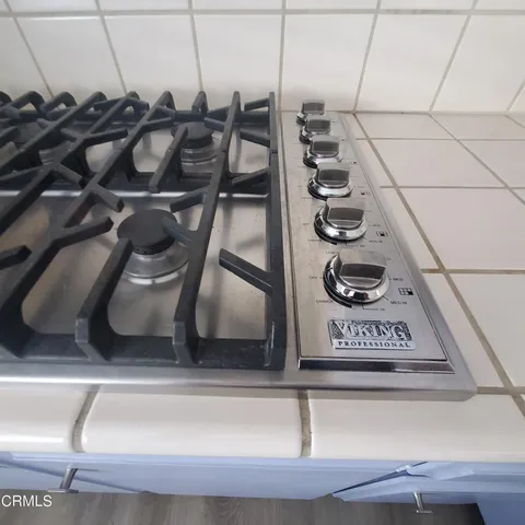 a stove top oven sitting inside of a kitchen