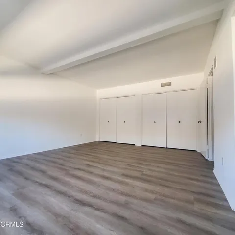 a bathroom with a granite countertop toilet sink and mirror