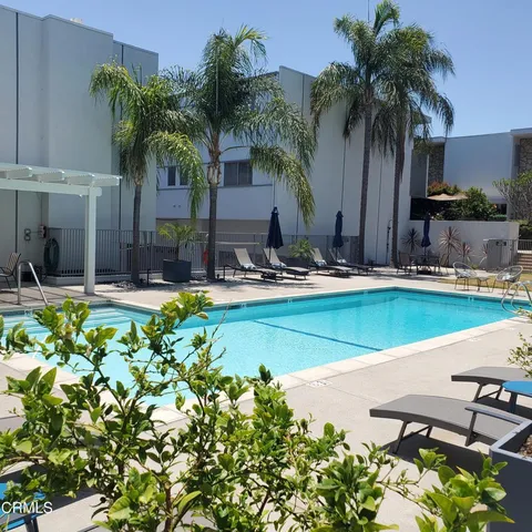 a swimming pool with outdoor seating and yard