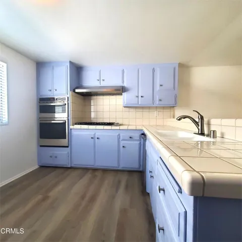 a kitchen with granite countertop a sink and cabinets