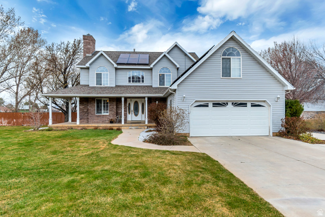 1697 North 500 West Mapleton, UT 84664 - Photo 2 of 50 Traditional-style home with a porch, solar panels, driveway, a chimney, and a shingled roof